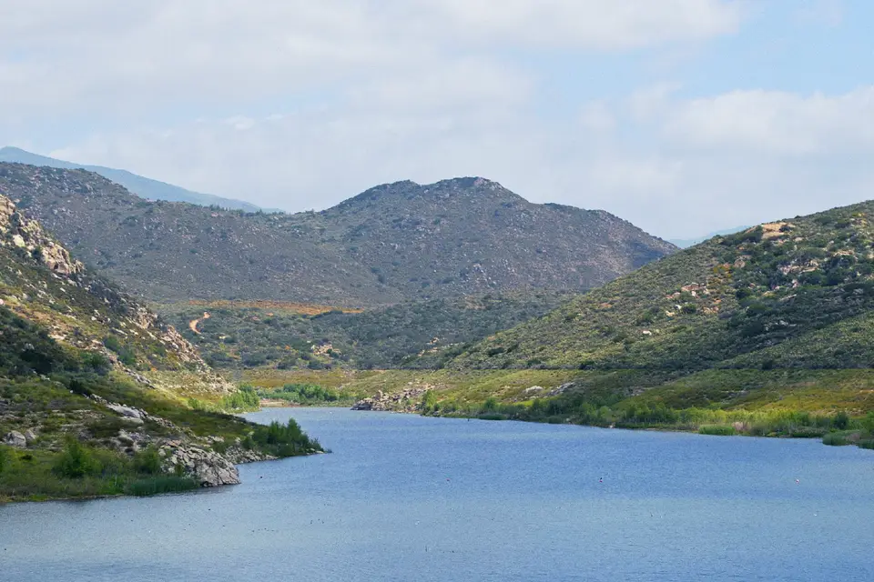 Loveland Reservoir surrounded by green chaparral-covered mountains near Alpine